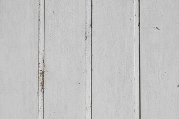 Weathered white wooden wall with vertical boards, cracked paint, dirt, and subtle cobwebs creating a rustic textured background