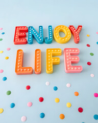 Vibrant 3d enjoy life lettering colorful confetti and light blue backdrop