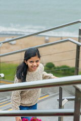 A young girl is smiling as she walks up a set of stairs