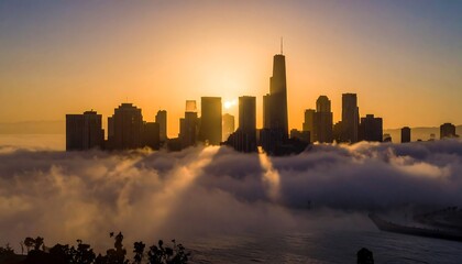 A stunning cityscape is silhouetted against a brilliant sunset. The dense fog envelops the lower buildings creating a dramatic scene