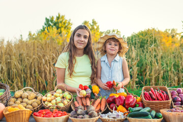 A child at a farmers market with vegetables. Selective focus.