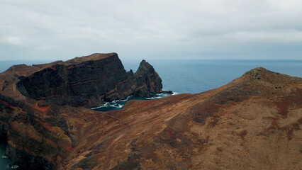 Obraz premium Stunning ocean cliffs stretching along misty horizon. Volcanic brown island