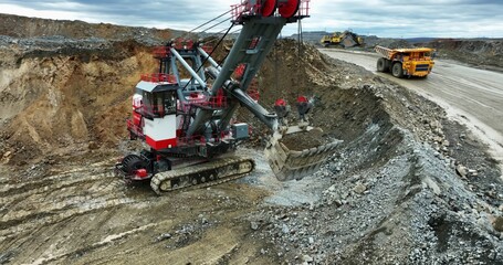Excavator loading dump truck in open pit mine. Stock clip