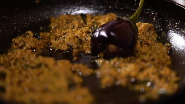 Stuffed Brinjal with Indian spices. Cooking whole egg plant.
