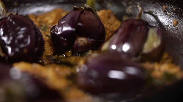 Stuffed Brinjal with Indian spices. Cooking whole egg plant.