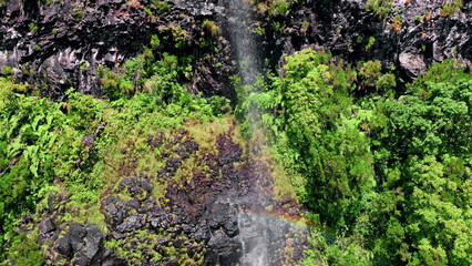 Water cascade flowing high cliffs aerial view. Panoramic waterfall hidden jungle