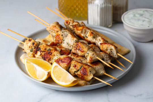 Greek grilled chicken skewers - chicken souvlaki served with lemon
