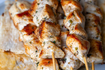 Greek grilled chicken skewers - chicken souvlaki served with lemon