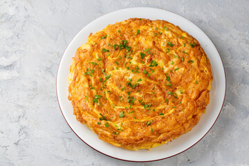 Spanish omelette with potatoes, typical spanish cuisine on gray concrete floor. Tortilla Espanola. Turkish name; Yumurtali patates
