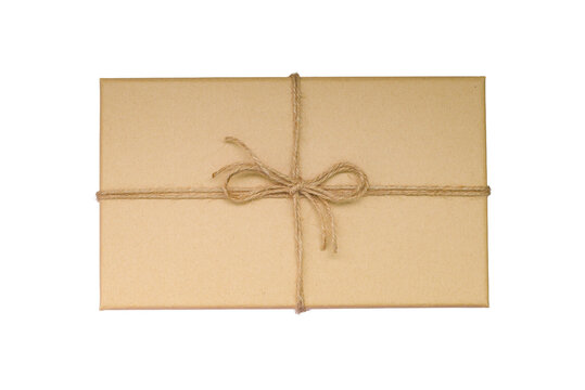 A craft gift box with a bow tied with string or twine. A textured craft gift box made of craft paper.