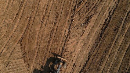 Grader leveling ground on construction site. Clip