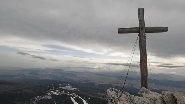 A wooden cross on a mountain top. High Tatras, Slovakia. View from the top of Front Solisko Mountain toward Strbske Pleso.
