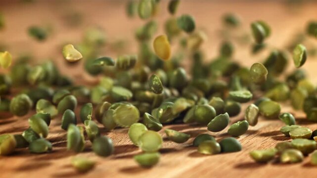Green peas fall on the table. Filmed on a high-speed camera at 1000 fps. High quality FullHD footage