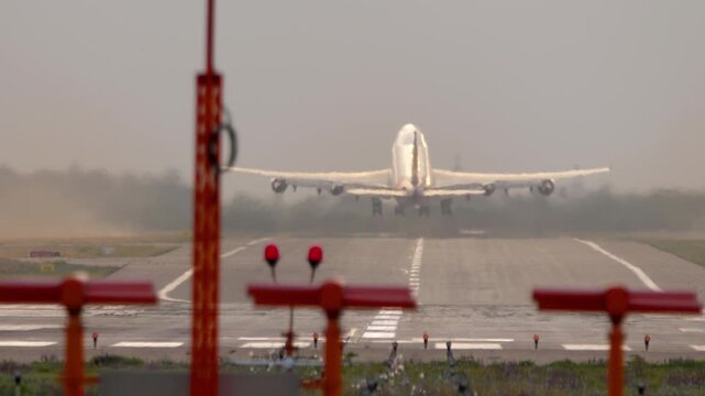 Footage heavy wide-body four-engine aircraft take off at sunrise or sunset backdrop. Aircraft departure