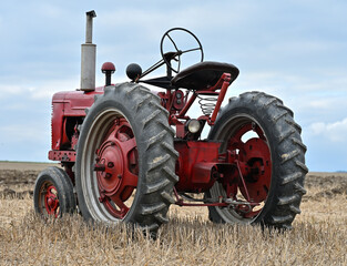 The historic tractor on a meadow agricultural machinery