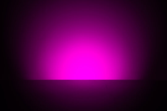 Abstract pink glow emerging from darkness, minimalist futuristic light horizon background
