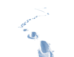 A solitary person walks through a vast expanse of white snow leaving footprints.