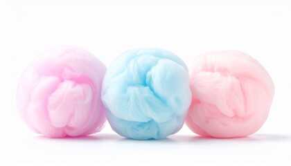 “Three pastel cotton-like balls—blue, pink, and peach—arranged side by side on white background, evoking softness, sweetness, and playful minimalism.”