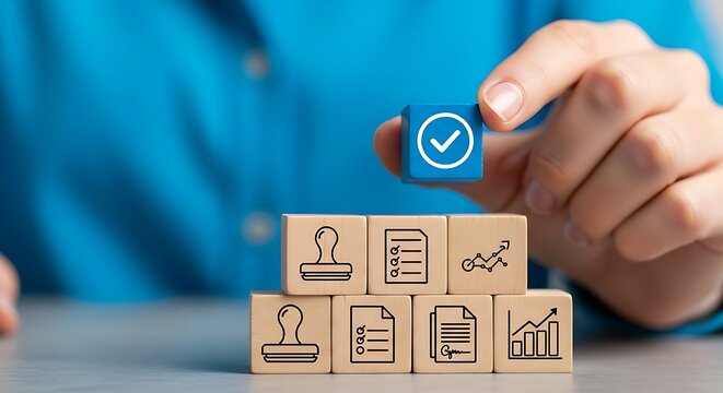A hand places a wooden block with a checkmark on top of other blocks with icons representing approval, document, chart, stamp, and graph, symbolizing quality control and validation