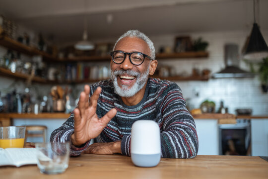 Smiling older man talking to an AI voice assistant smart speaker