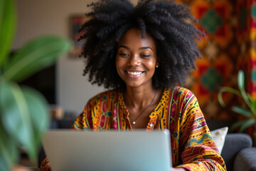 African American woman captivated by laptop amidst blend of African fabrics and digital tools.
