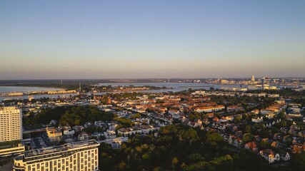 Rostock, Germany – August 17, 2024: Aerial view of Warnemünde Beach on the Baltic Sea at sunset. Hotels, beach chairs, and promenade along the scenic coastline.