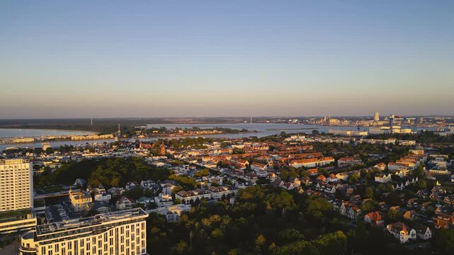 Rostock, Germany – August 17, 2024: Aerial view of Warnemünde Beach on the Baltic Sea at sunset. Hotels, beach chairs, and promenade along the scenic coastline.