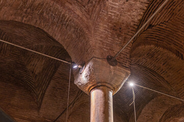 Ancient underground basilica cistern architecture with illuminated pillars and arched ceiling