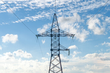 Silhouette of high voltage metal pillar with power line wires. Front view.
