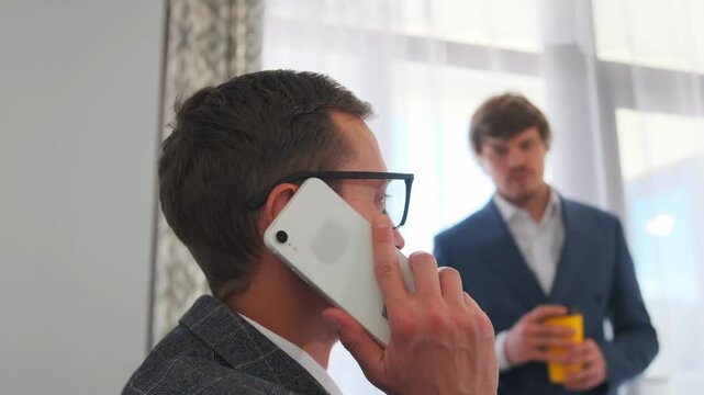 leadership communicates during work hours, corporate executive conducting critical phone discussion, highranking corporate professional engaged in essential phone conversation amidst office