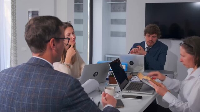 lawyers deliberate on contractual provisions, legal professionals analyze and debate contract terms carefully, team of legal experts thoroughly reviews and discusses contractual clauses in formal