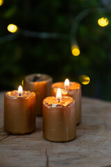 candles burning in front of fir tree