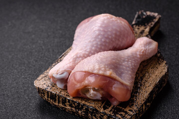 Raw chicken legs, poultry meat on the bone for barbecue. Chicken legs as a food background