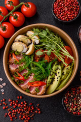 Seared tuna tataki in a bowl with sesame seeds, rice, and vegetables. Tuna tataki