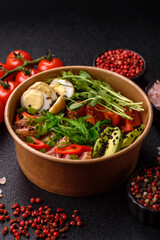 Seared tuna tataki in a bowl with sesame seeds, rice, and vegetables. Tuna tataki