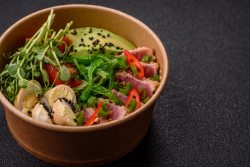 Seared tuna tataki in a bowl with sesame seeds, rice, and vegetables. Tuna tataki