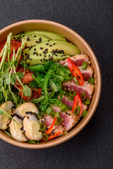Seared tuna tataki in a bowl with sesame seeds, rice, and vegetables. Tuna tataki