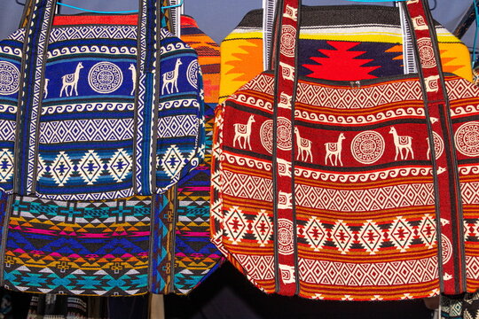 Textile bags with traditional Andean patterns at the weekly Plaza de los Ponchos market in Otavalo, Ecuador