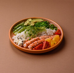 A prawn or shrimp bowl with rice, tomatoes, sauce, and vegetables, Asian food. Prawn or shrimp
