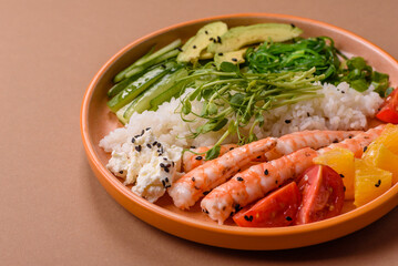 A prawn or shrimp bowl with rice, tomatoes, sauce, and vegetables, Asian food. Prawn or shrimp