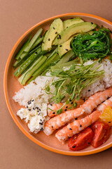 A prawn or shrimp bowl with rice, tomatoes, sauce, and vegetables, Asian food. Prawn or shrimp