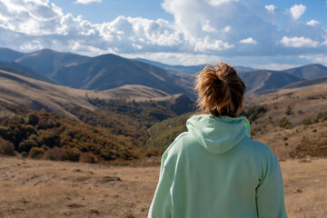 Woman admiring vast mountain landscape vista