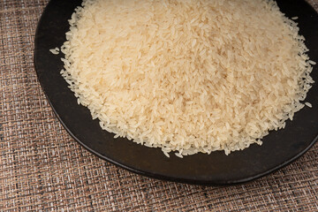 White parboiled rice grains. Dry uncooked ponni rice, small organic basmati