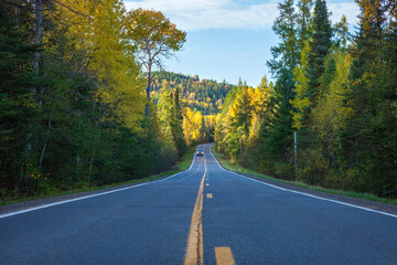 Low angle view of the Gunflint Trail under hills in northern Minnesota at sunset during autumn