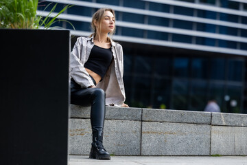 Fototapeta premium Beautiful Woman Posing in Leather Pants, Modern Style in City Geometry