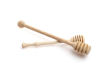 Wooden honey dipper sticks, one with a rounded end and the other with a spiral design, resting on a clean white background, perfect for culinary and kitchen use