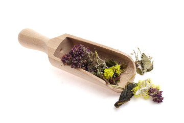 Wooden scoop filled with dried herbs and flowers, showcasing vibrant colors and textures, perfect...