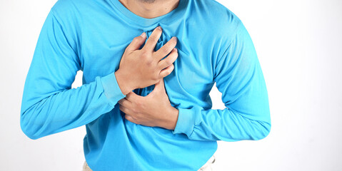 Close-up. Man's hand holding his chest. Chest pain. Man in pain massaging the affected area, Chest pain can be caused by heart attack, myocardial infarct or ischemia, myocarditis, pneumonia. Emergency