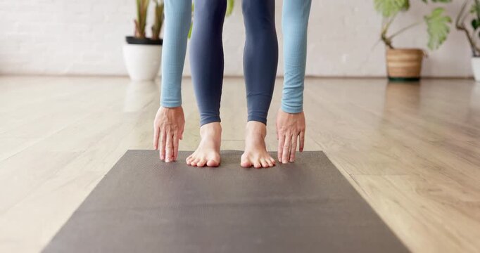 Yoga mat, hands and stretching in studio for wellness, health and person with holistic workout. Yogi, woman and exercise for flexibility, practice and pilates for balance with feet in fitness club