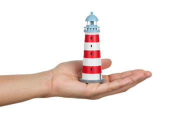 Miniature lighthouse in hand isolated on transparent PNG, red and white striped nautical decoration for travel and coastal themes